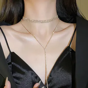 Close-up detail of sparkly rhinestone choker and Y-shaped tassel necklace on model