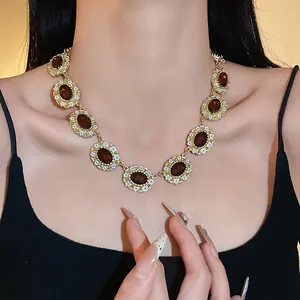 Close-up of a vintage palace-style oval rhinestone necklace with oil-dripped flowers