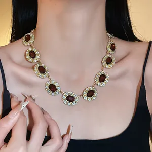 Vintage palace style oval necklace with enamel flowers, retro luxury detail.