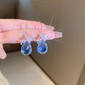 Detailed view of elegant blue teardrop earrings with sparkling zircon floral accents