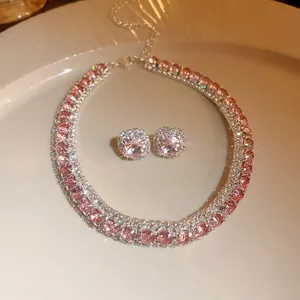 Detailed view of pink zircon necklace and earring set with shimmering crystal accents