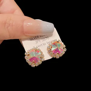 Macro view of iridescent crystal halo stud earrings with sparkling zircon accents
