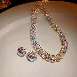 Macro view showing the detailed iridescent zircon necklace and matching gold stud earrings