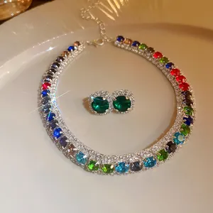 Close-up of luxury multi-colored rhinestone necklace and emerald green earring set