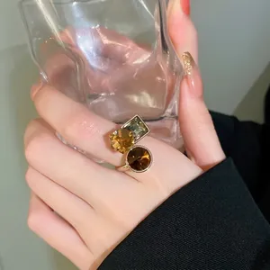 Luxury gold plated open ring with geometric chocolate zircon stones on female hand