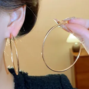 Large 18K gold plated hoop earrings with silver pins for women in a minimalist style