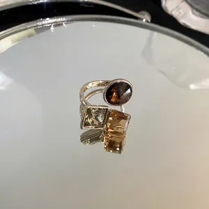 Gold plated open ring with square and round zircon stones in chocolate and champagne tones