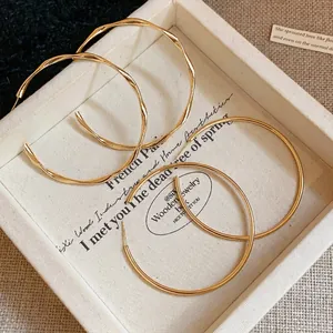 Minimalist gold plated hoop earrings set featuring smooth and twisted texture designs