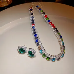 Close-up detail of colorful gemstone zircon necklace and emerald green earrings jewelry set
