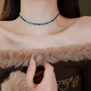 Close-up of multi-colored zircon choker necklace on a model wearing a brown fur collar sweater