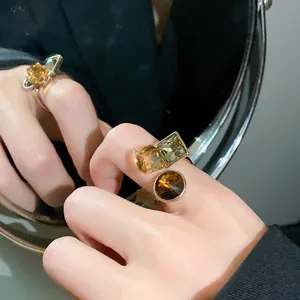Macro shot of a chocolate gold ring featuring geometric square and round zircons