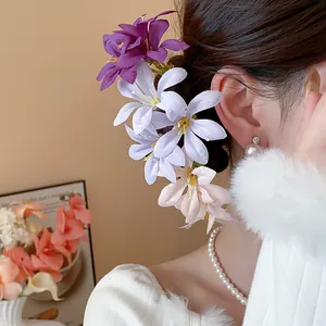 Detail view of elegant Korean style fabric flower hairpins in purple and pink tones