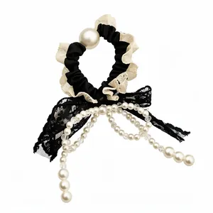 Elegant French style lace bow hair scrunchie with pearls for women on white background.