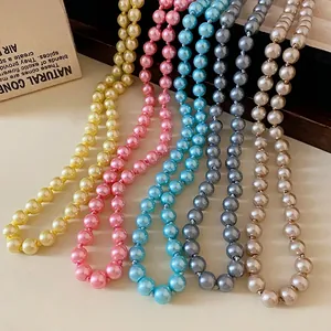 Elegant collection of five multi-colored long pearl necklaces displayed on a jewelry stand
