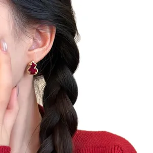 Elegant red gourd stud earring with gold plating and zircon, shown on model
