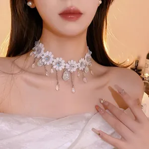 Elegant white floral lace choker with pearl pendants worn by a beautiful model