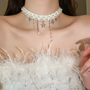 Close-up detail of elegant white lace choker necklace with pearls and star charms
