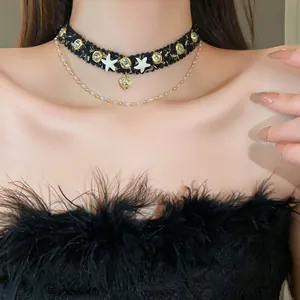 Close-up view of a sweet-style black woven choker with starfish and heart charms on a model.