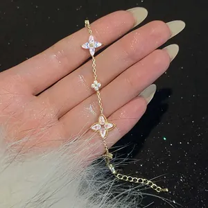 Close-up of elegant gold-plated flower bracelet with sparkling zircons on hand