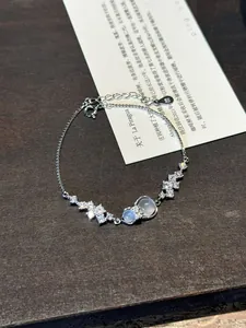 Detailed shot of a silver gourd bracelet with sparkling cubic zirconia flower accents