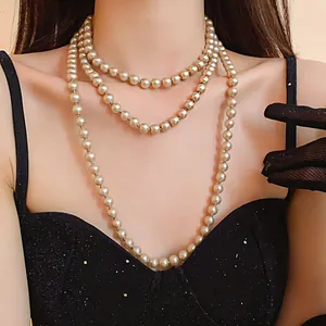 Close-up detail of elegant multi-layer long pearl necklace with champagne luster