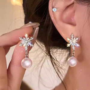 Sparkling snowflake pearl drop earrings with silver pins for elegant winter jewelry