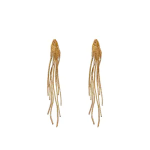 Elegant golden metal tassel earrings with geometric minimalist design on white background