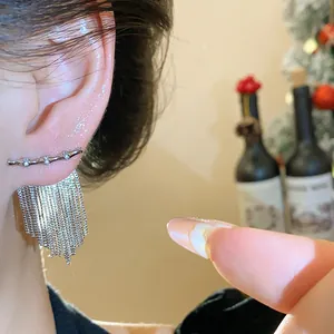 Gros plan élégant de boucles d'oreilles à pompons en zircon plaqué or 14 carats