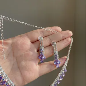 Elegant silver-toned jewelry set with purple water-drop crystals and clear rhinestones