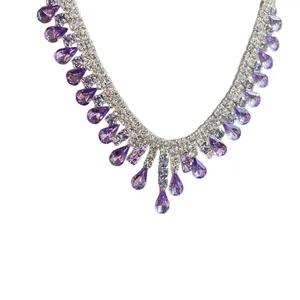 Elegant silver-tone necklace featuring purple teardrop crystals and clear rhinestones
