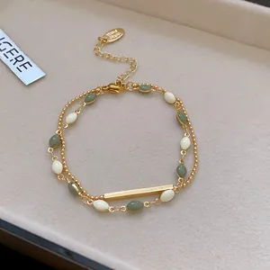 Bohemian style gold-tone multi-layer beaded bracelet with olive green and white accents