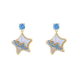 Gold-plated silver needle star earrings with blue crystals and white resin inlay