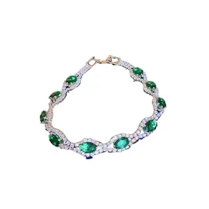 Elegant court style bracelet featuring green oval crystals and sparkling pavé diamonds