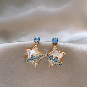 Detailed view of elegant star-shaped stud earrings featuring blue and clear crystals