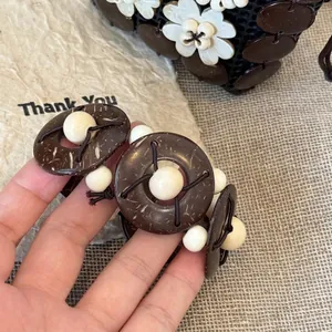 Detailed close-up of neo-Chinese style wooden bead bracelet with natural coconut shell discs