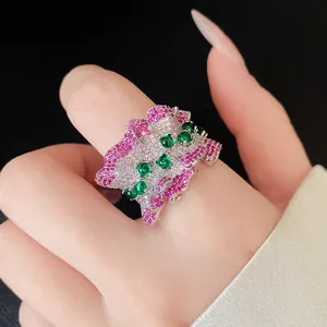 Macro view of luxury Korean style ruffled irregular open ring with pink and green zircons