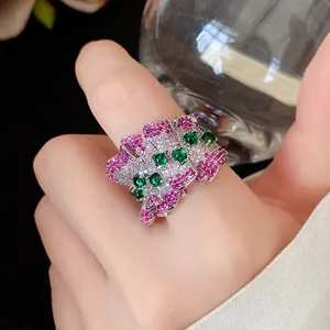 Detail view of a luxury pleated irregular open ring with pink, white and green zircon