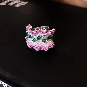 Detailed view of irregular pleated ring with pink and green zircon pavé setting