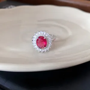 Macro detail of elegant red zircon ring with halo of white stones
