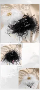Detailed close-up showing the soft texture of black and white feather hair claw clips