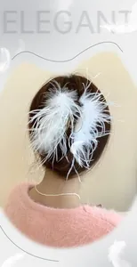 Detailed view of an elegant white feather hair claw clip worn on a bun for a fairy look