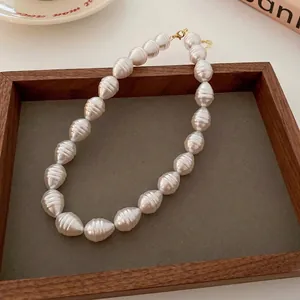 Vintage Baroque gradient pearl necklace with elegant ribbed texture in a wooden tray