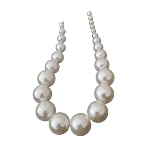 Elegant vintage graduated white faux pearl necklace for women with a minimalist design aesthetic