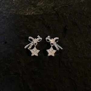 Elegant sparkling silver needle stud earrings with zircon bow and dangling star design