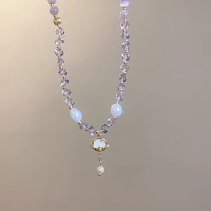 Detailed shot of cat's eye and crystal beaded jewelry featuring a stylish planet pearl pendant