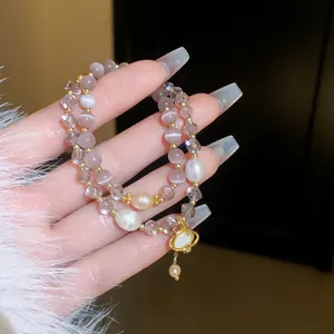 Macro view showing the elegant cat's eye stones and crystal beads on a double-layer bracelet