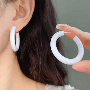 Elegant white acrylic C-shaped hoop earrings with silver needles for a trendy sweet look