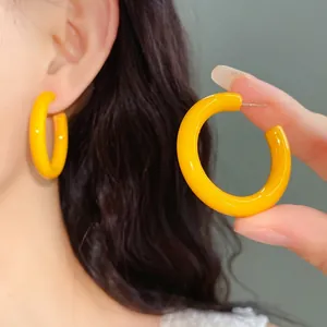 Bright yellow acrylic C-shaped hoop earrings with silver needle posts for women