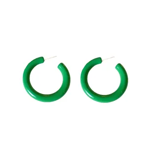 Green acrylic C-shaped hoop earrings with silver posts on white background