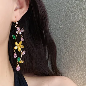 Close-up of elegant flower and butterfly tassel earrings with colorful zircons
